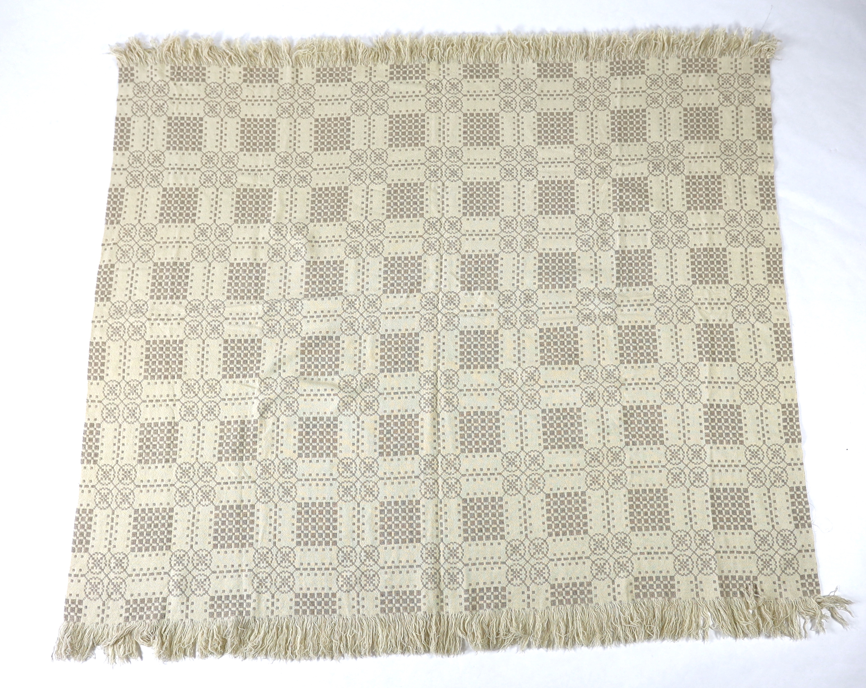 A Welsh wool woven blanket, using mushroom and cream wool in a reversible geometric design, 192cm wide x 212cm long